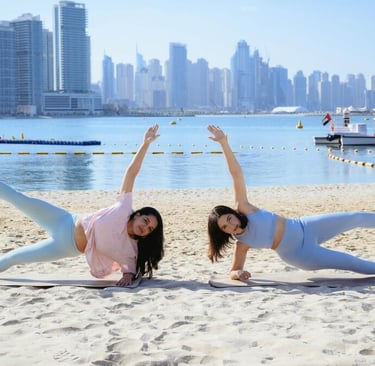 Women practicing online yoga at the beach in dubai