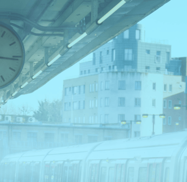 image of a clock on a train podium surrounded by fog