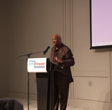 A man speaking at a podium during the Fort Wayne emPower Breakfast event.