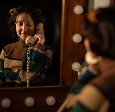 Maria in a sweater with a teddy bear on her phone