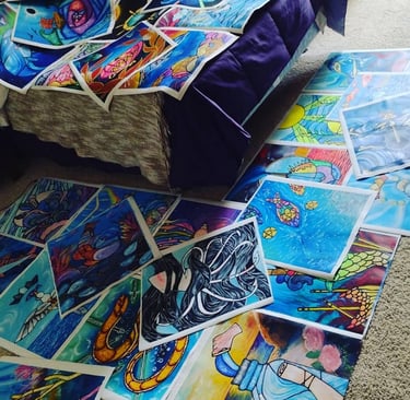 Photo of completed paintings on loose canvas spread out over artists's bedroom floor