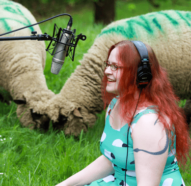 Rachael with her recording equipment out in the sheep field
