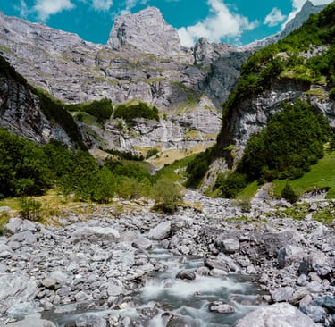 a mountain stream running through a rocky mountain