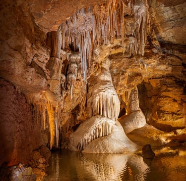 a cave with a waterfall and a waterfall