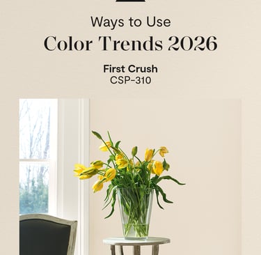 Yellow tulips in a glass vase against a beige First Crush paint color wall for 2026 interior trends.