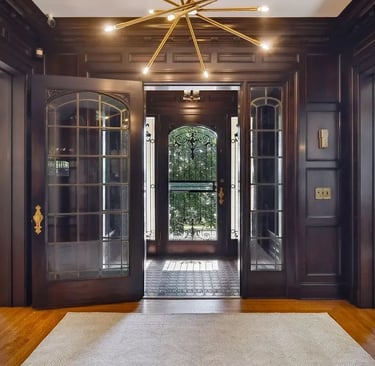 a large foyer with a chandelier and a chandelier