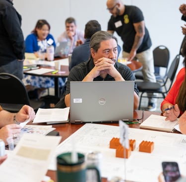 At a Leadership Austin class, participants gather around a table for a lively group discussion
