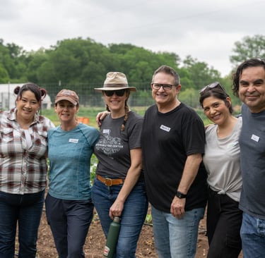Francisco Gamez stands with his cohort from Leadership Austin at Urban Roots
