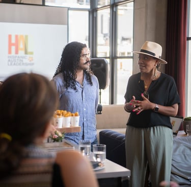 Tito Sandigo and Monica Muñoz Andry speak passionately at a Hispanic Austin Leadership meeting.