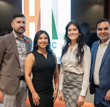 Arnaldo, Claudia, Jenny, and Francisco smile together at a Hispanic Austin Leadership event