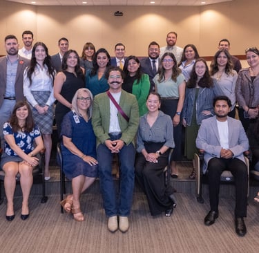 Francisco stands proudly with Hispanic Austin Leadership classmates, gathered for a group photo