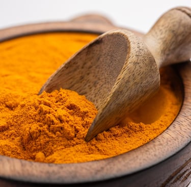 Turmeric powder in a wooden bowl