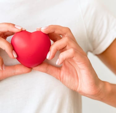 Front view of woman holding heart shape
