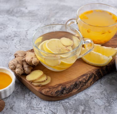 Turmeric, lemon, and ginger detox water in two cups