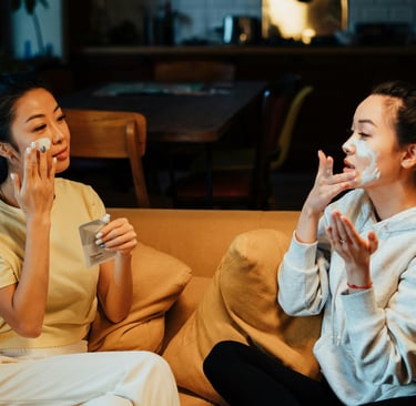 two woman applying face cream