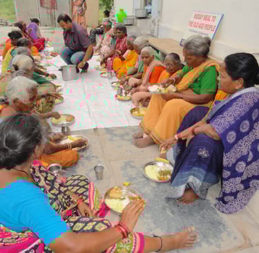 a group of people sitting around on floor with food