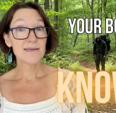 a woman with glasses and a hiker in the woods