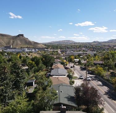 Drone shot of a neighborhood in Golden looking at Coors and South Table Mountain