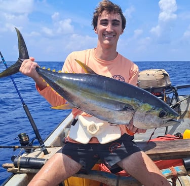 Happy client with a yellowfin tuna on a Zanzibar Catamaran Fishing Charter