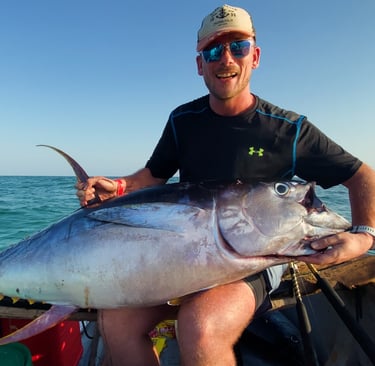  client with a tuna on a Zanzibar Catamaran Fishing Charter