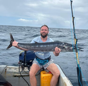 Angler holding a Wahoo in Zanzibar waters