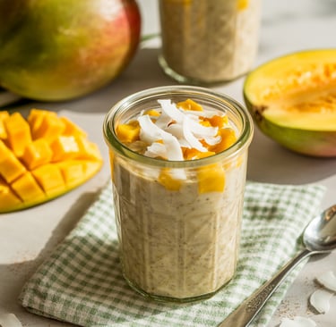 a glass jar of oatmeal with a spoon and spoon next to it