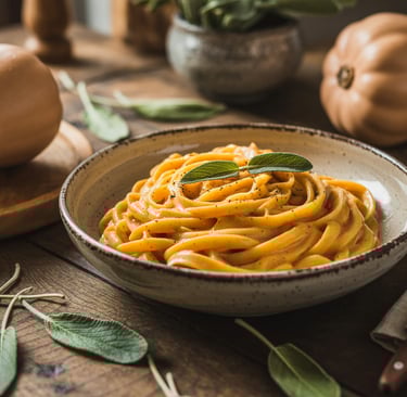 a bowl of pasta with a fork and a knife