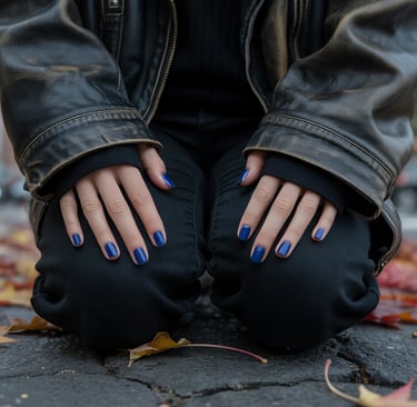 a woman with blue nails and a black jacket