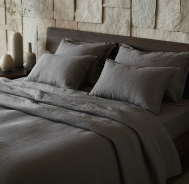 a bed with a large bed and a vase with flowers