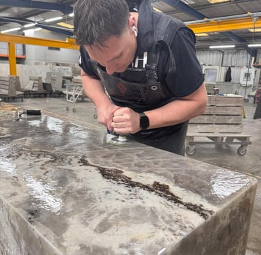 RH Stone Surfaces fabricator polishing a granite kitchen worktop in our North East factory