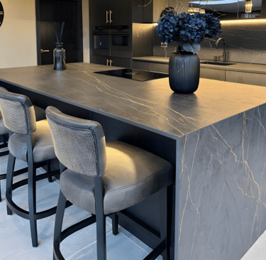Dark marble-effect porcelain kitchen island with waterfall edges installed by RH Stone Surfaces in t