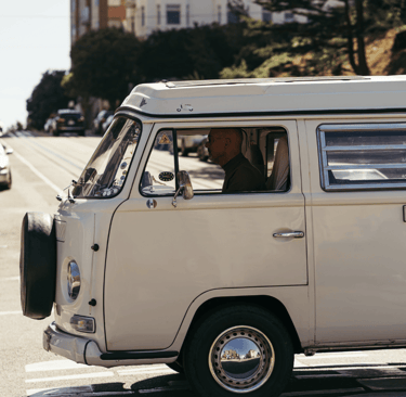 A van in Surrey, BC, with a dog sitting in the driver's seat of a van