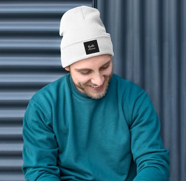 a man in a blue sweater and a white beanie hat