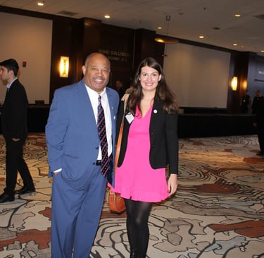 Dominic Carter speaking in Albany NY at a foster care conference, pictured with an attendee.