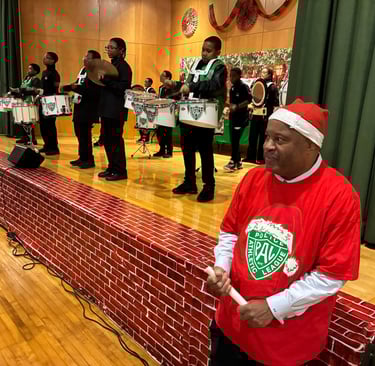 Child advocate and author Dominic Carter wearing a red Santa hat and red PAL Christmas shirt