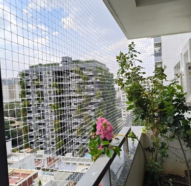 Daylight view of a balcony protected by tightly woven safety netting against pets and children.