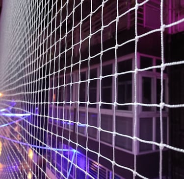 Close-up of a freshly installed pigeon net stretched tightly across a balcony.