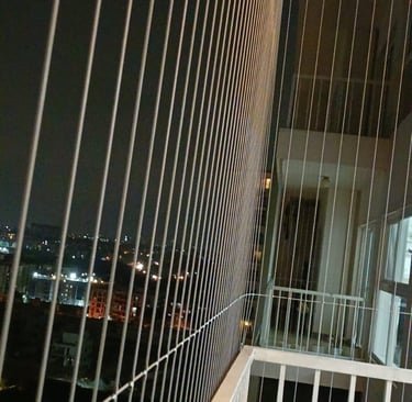 Invisible grills fitted seamlessly on a window, blending with the frame.