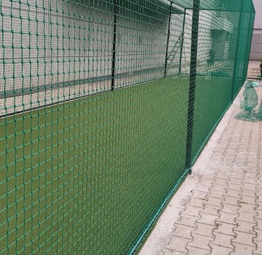 Action shot of a football net catching a ball during a lively match at a local park.