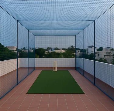 Wide shot of a football field surrounded by sturdy safety nets in Electronic City.
