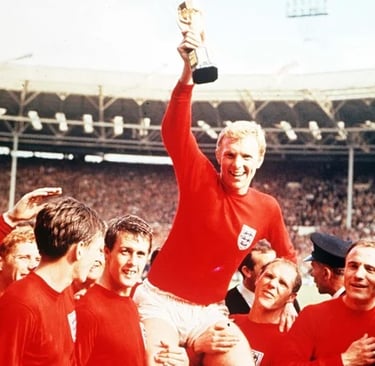 Bobby Moore surrounded by England team mates as he holds up the 1966 World Cup