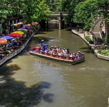 A river boat glides past restaurants on San Antonio's River Walk