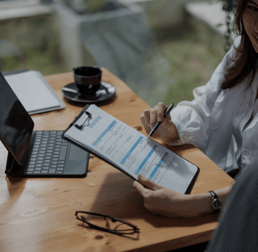 a woman in a white shirt is holding a clipboard