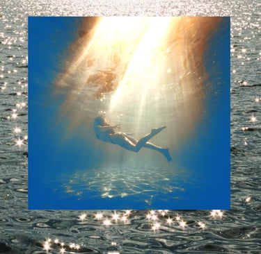 person swimming in deep water with beautiful light shining from above and sparkling ocean waves
