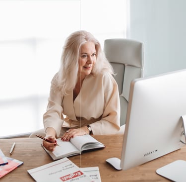 A professional woman at her desk with a computer, reviewing documents about the ADA Tax Credit for s
