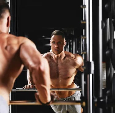 a man in a gym with a barbell