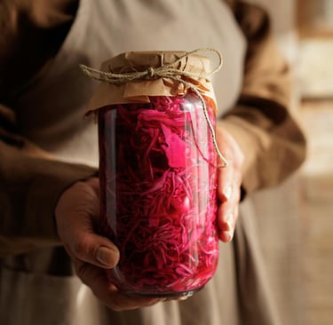 a woman holding a jar of red cabbage sauerkraut