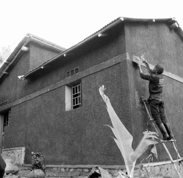 black and white photo of team building a new home in rwanda