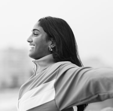 a woman with her arms outstretched out and smiling