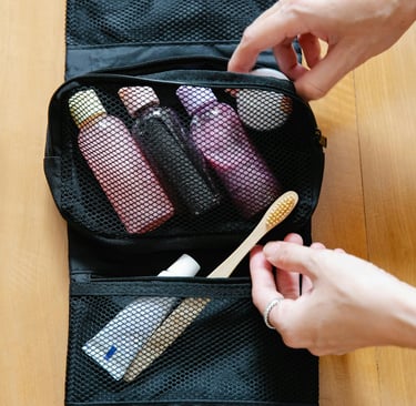 a person holding a bag with a toothbrush and toothbrush